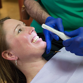 woman getting teeth cleaned at albright dental